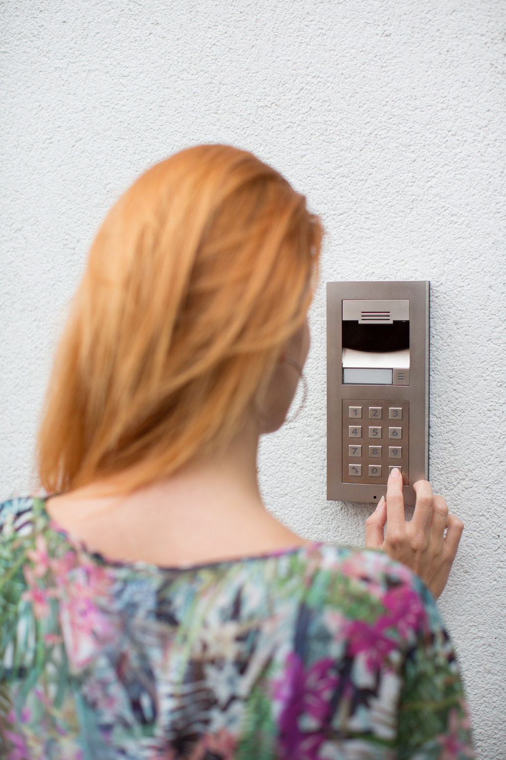 Lady using our Control4 home security access panel
